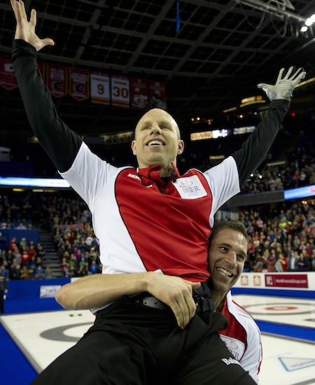Pat Simmons is hoisted by teammate John Morris after winning the Tim Hortons Brier a year ago in Calgary. (Photo, Curling Canada/Michael Burns)