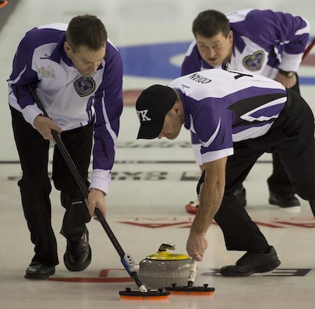 Yukon skip Bob Smallwood, top left, gives instructions to sweepers Clint Abel, left, and Scott Odian. (Photo, Curling Canada/Michael Burns