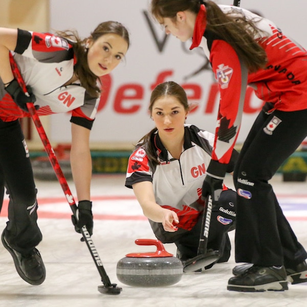 Team Canada lead Janique LeBlanc and third Kristin Clarke get ready to sweep second Karlee Burgess's rock during the Gold Medal Game of the 2016 World Junior Curling Championships in Taarnby, Denmark (WCF/Richard Gray photo)